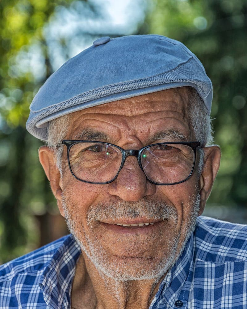 A smiling older man outdoors.